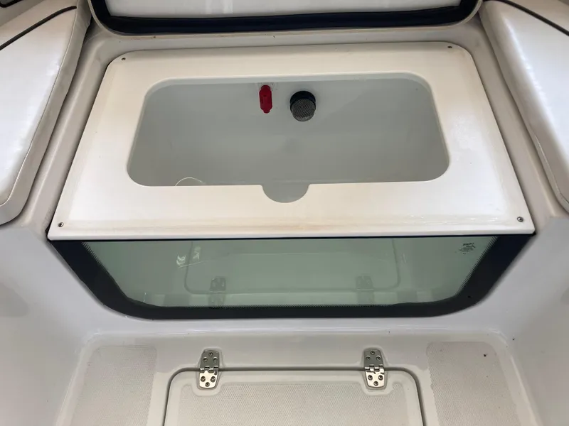 Slide: The Image of Livewell compartment on a 2022 Wellcraft 202 Fisherman boat, featuring a transparent front panel. - 22