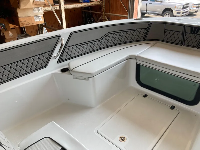 Slide: The Image of 2022 Wellcraft 202 Fisherman boat interior with cushioned seating and storage compartments. - 24