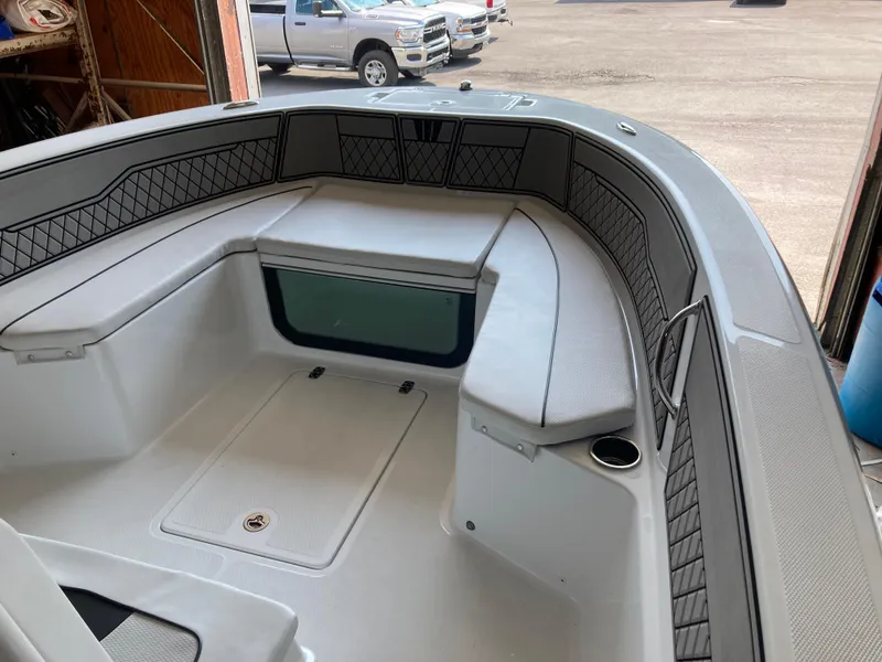 Slide: The Image of 2022 Wellcraft 202 Fisherman boat interior with cushioned seating and storage compartments. - 25