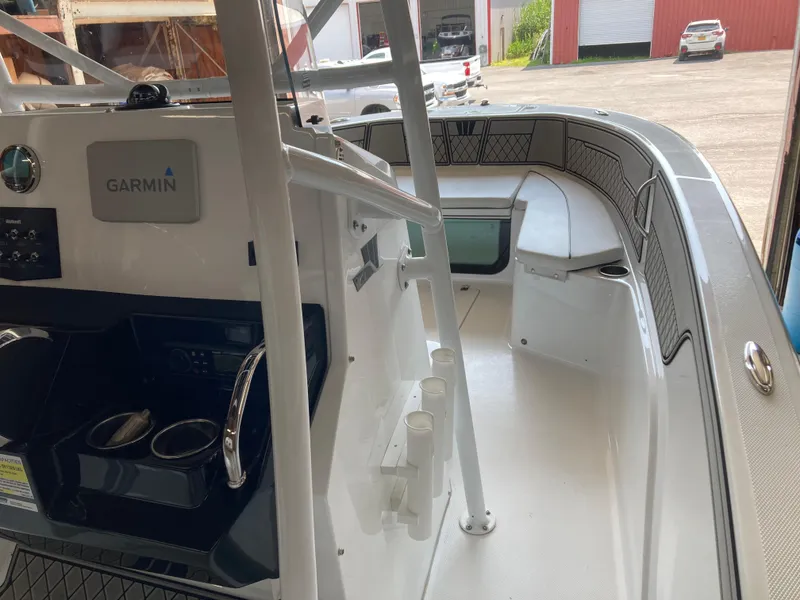 Slide: The Image of 2022 Wellcraft 202 Fisherman boat interior with Garmin equipment and seating area. - 26