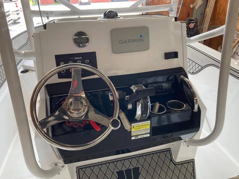 Slide: The Image of 2022 Wellcraft 202 Fisherman boat console with Garmin navigation and steering wheel. - 28