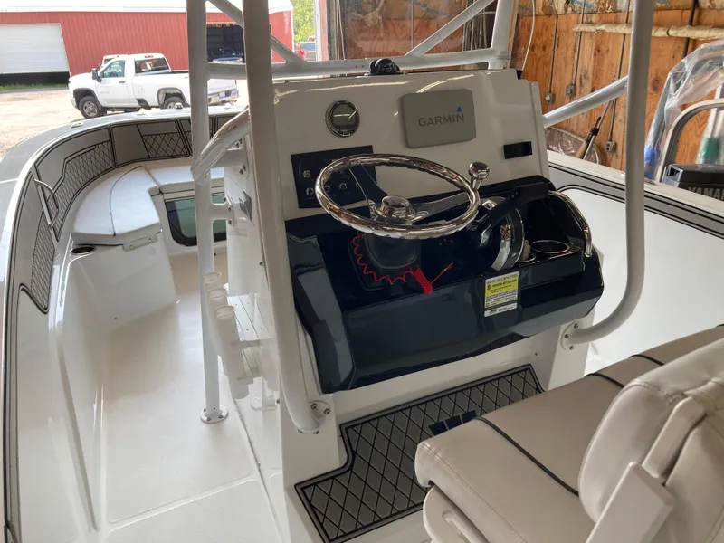 Slide: The Image of 2022 Wellcraft 202 Fisherman boat interior with Garmin navigation system and steering wheel. - 29