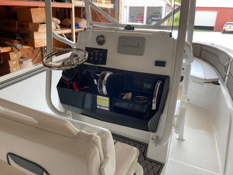 Slide: The Image of 2022 Wellcraft 202 Fisherman boat interior with Garmin navigation system and steering console. - 30