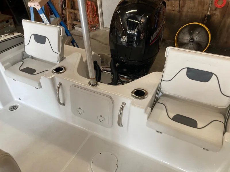 Slide: The Image of 2022 Wellcraft 202 Fisherman boat interior with seating and Mercury outboard motor. - 32