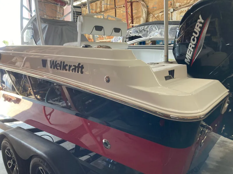 Slide: The Image of 2022 Wellcraft 202 Fisherman boat with Mercury engine in a garage setting. - 34