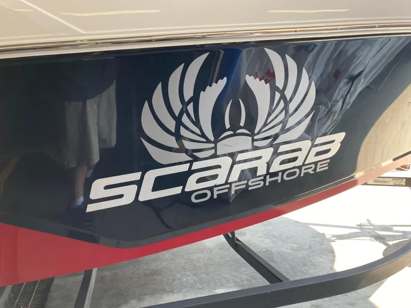 Slide: The Image of 2022 Wellcraft 202 Fisherman boat with Scarab Offshore logo on the side. - 35