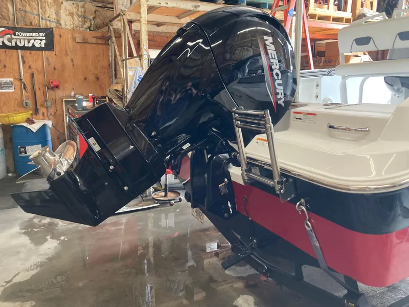 Slide: The Image of 2022 Wellcraft 202 Fisherman boat with Mercury outboard motor in a workshop setting. - 36
