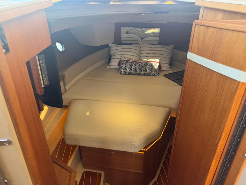 Slide: The Image of 2019 Ranger Tugs R-29 CB interior with dining area, wooden table, and seating. - 10