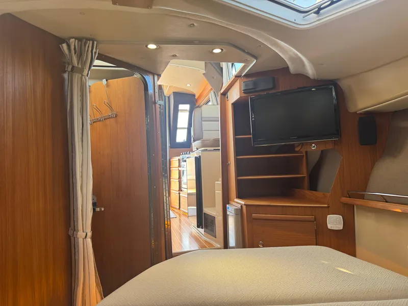 Slide: The Image of 2019 Ranger Tugs R-29 CB interior with kitchen, seating, and wood finish. - 11