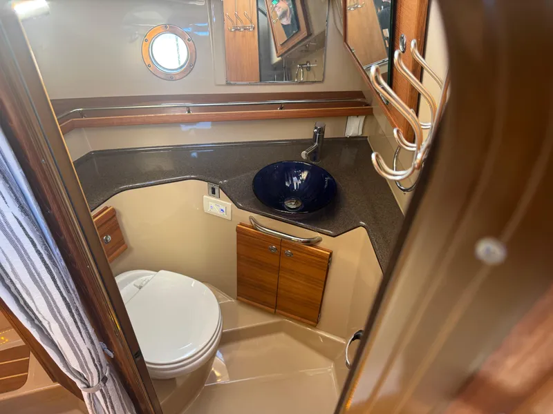 Slide: The Image of Interior of 2019 Ranger Tugs R-29 CB with wood finish, TV, and cozy seating area. - 13
