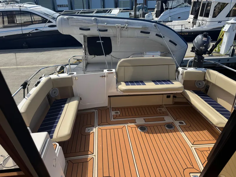 Slide: The Image of Interior of 2019 Ranger Tugs R-29 CB, featuring wood paneling and a compact bathroom. - 14