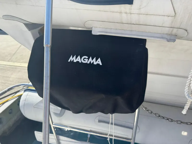 Slide: The Image of 2019 Ranger Tugs R-29 CB interior storage area with beige cushions and wooden trim. - 24