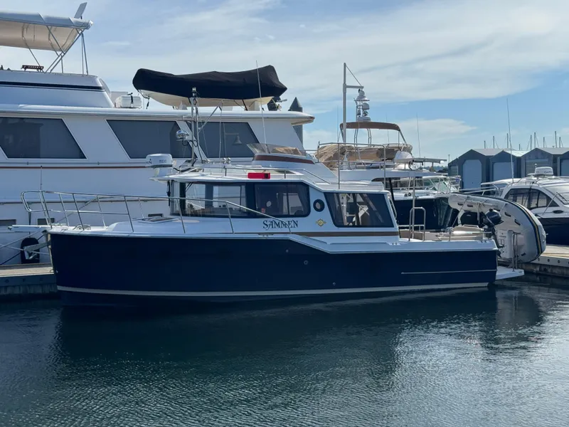 Slide: The Image of 2019 Ranger Tugs R-29 CB boat docked at marina, side view. - 27