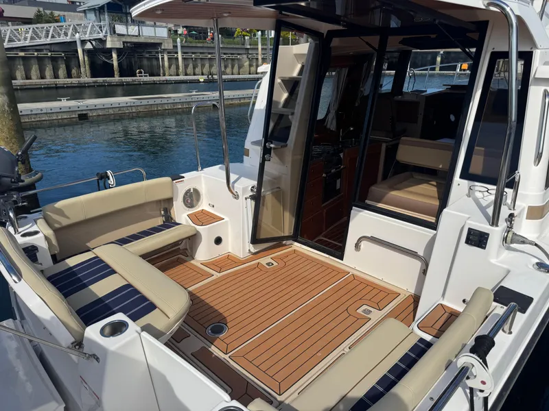 Slide: The Image of 2019 Ranger Tugs R-29 CB docked at marina under clear blue sky. - 3