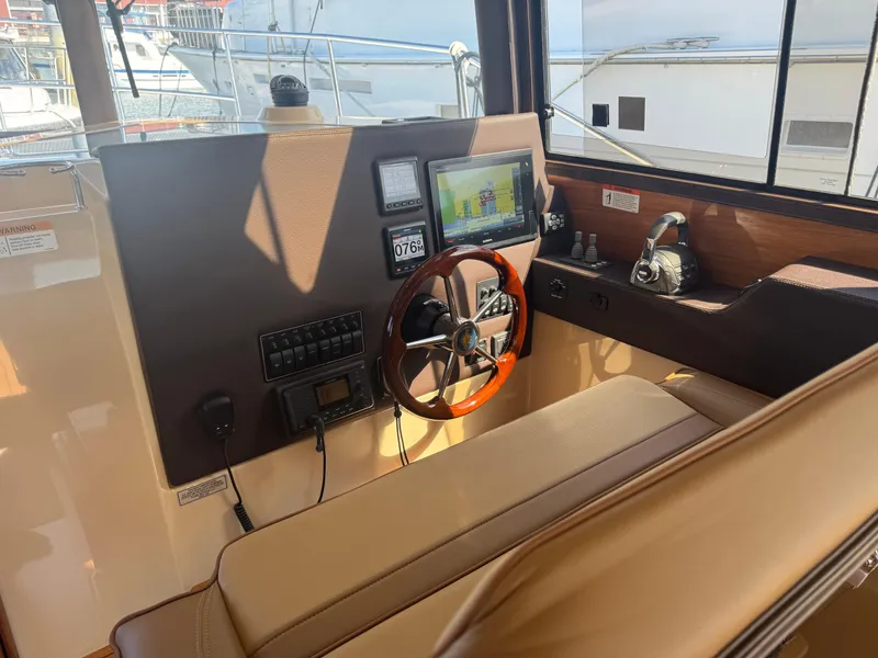 Slide: The Image of 2019 Ranger Tugs R-29 CB interior kitchen with stove, sink, and wooden cabinetry. - 6