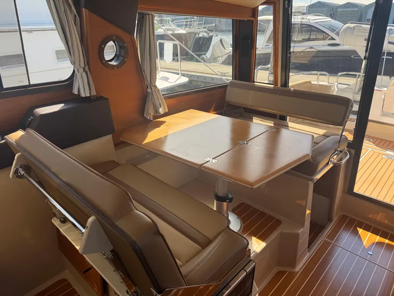 Slide: The Image of 2019 Ranger Tugs R-29 CB helm with navigation screen and wooden steering wheel. - 8