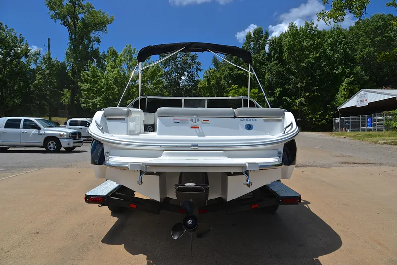 Slide: The Image of Rear view of a 2011 Cobalt 200 boat on a trailer, surrounded by trees. - 13