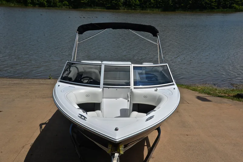 Slide: The Image of 2011 Cobalt 200 boat on a trailer by a lake. - 17