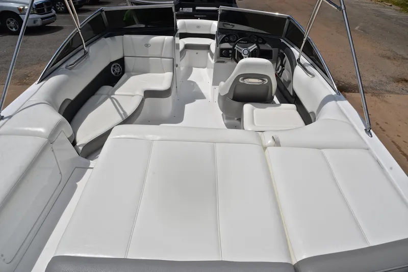 Slide: The Image of 2011 Cobalt 200 boat interior with white seating and steering console. - 18