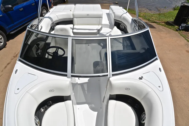Slide: The Image of 2011 Cobalt 200 boat with white interior, parked near a lake. - 20