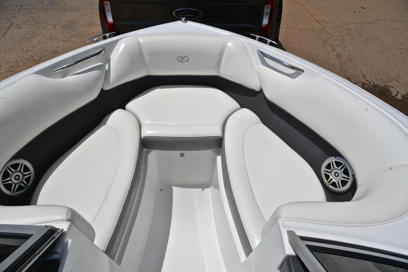 Slide: The Image of Interior of a 2011 Cobalt 200 boat with white seating and speakers. - 21