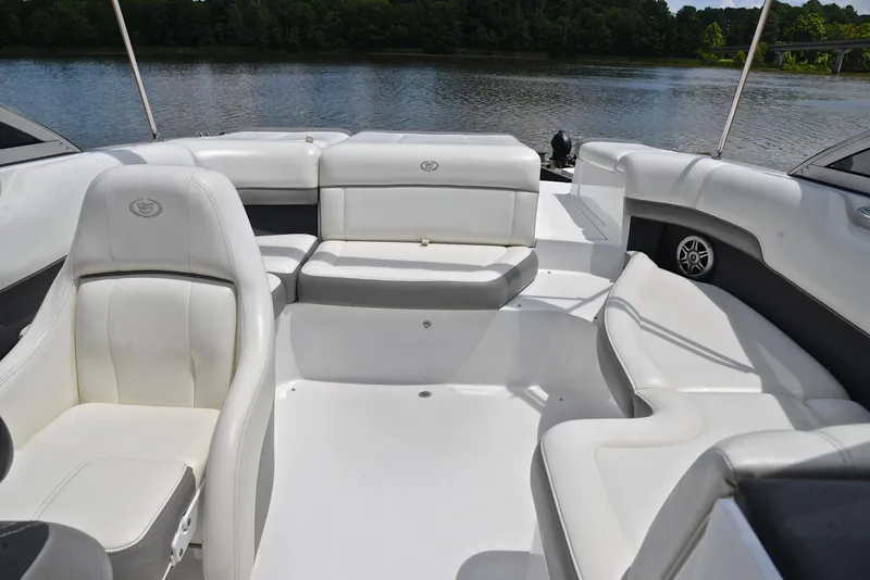 Slide: The Image of Luxurious seating on a 2011 Cobalt 200 boat, with white upholstery and scenic lake view. - 22