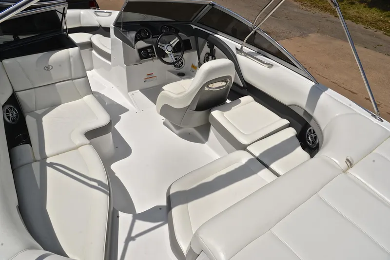 Slide: The Image of 2011 Cobalt 200 boat interior with white seating and steering wheel. - 23