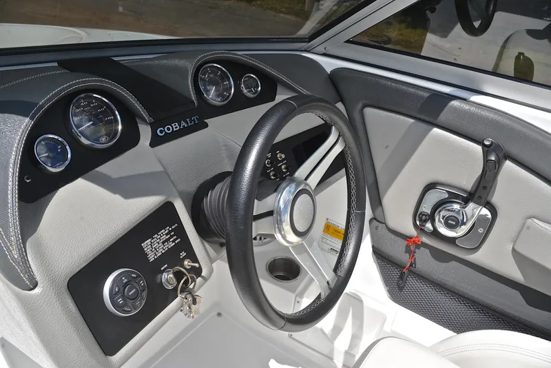 Slide: The Image of Steering console of a 2011 Cobalt 200 boat with gauges and controls. - 26