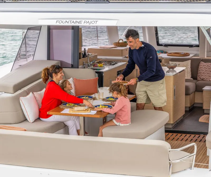 Slide: The Image of Family dining on Fountaine Pajot NEW 41 yacht, 2025 model, enjoying a meal together. - 32