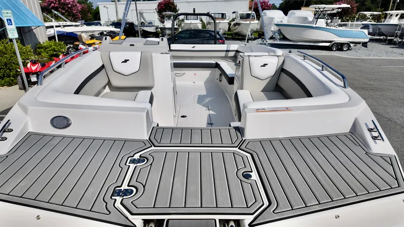 Slide: The Image of 2026 Starcraft SVX 191 OB boat with spacious seating and sleek design in a showroom. - 11