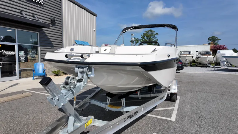 Slide: The Image of 2026 Starcraft SVX 191 OB boat on trailer outside dealership, sunny day. - 12