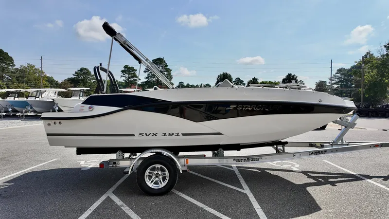 Slide: The Image of 2026 Starcraft SVX 191 OB boat on trailer in parking lot, sunny day. - 13