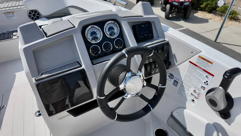 Slide: The Image of 2026 Starcraft SVX 191 OB boat dashboard with steering wheel and control panel. - 7