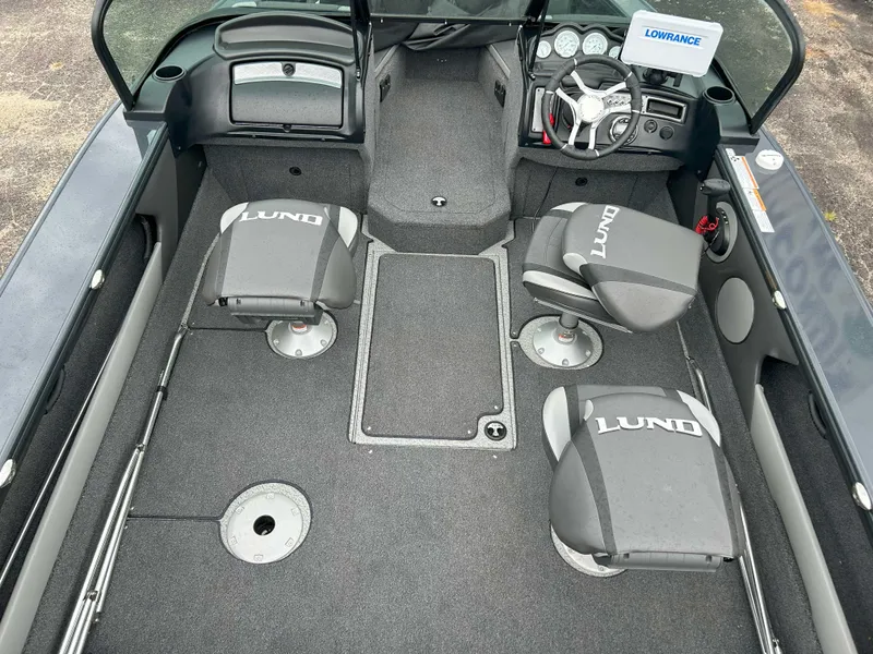 Slide: The Image of 2024 Lund 1875 Crossover XS boat interior with seating and steering console. - 4