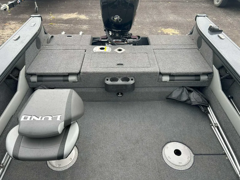 Slide: The Image of 2024 Lund 1875 Crossover XS boat interior with seating and storage compartments. - 6