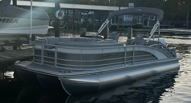 Slide: The Image of 2024 Bennington R 23 Swingback pontoon boat docked on calm water. - 3