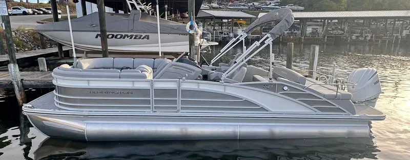 Slide: The Image of 2024 Bennington R 23 Swingback pontoon boat docked at a marina. - 4