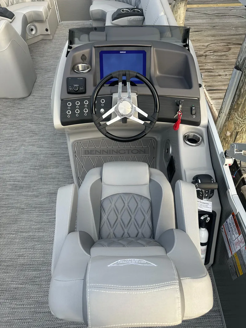 Slide: The Image of 2024 Bennington R 23 Swingback boat helm with steering wheel and control panel. - 9