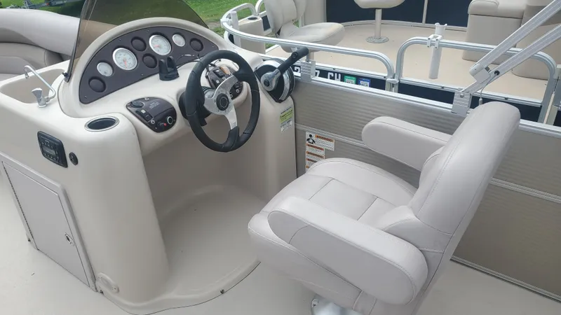 Slide: The Image of Captain's seat and helm of 2014 Starcraft SD 190 boat, featuring steering wheel and gauges. - 5