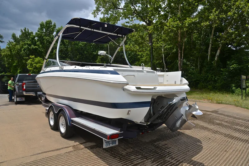 Slide: The Image of Cobalt 246 boat on trailer, parked near trees, ready for launch. - 13