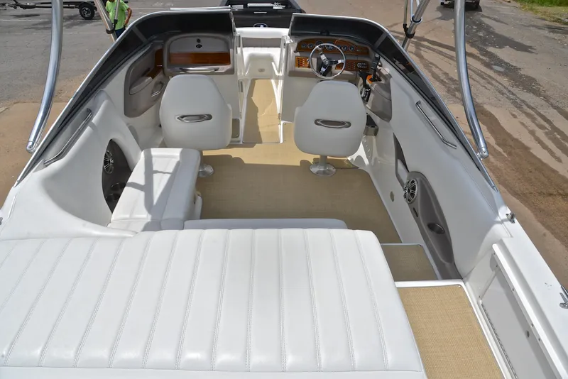 Slide: The Image of Interior of a 2000 Cobalt 246 boat with white seating and modern dashboard. - 19