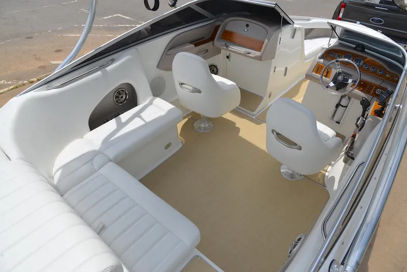 Slide: The Image of Interior of a 2000 Cobalt 246 boat with white seating and modern dashboard. - 20