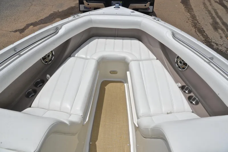 Slide: The Image of Interior of a 2000 Cobalt 246 boat with white leather seating and cup holders. - 22