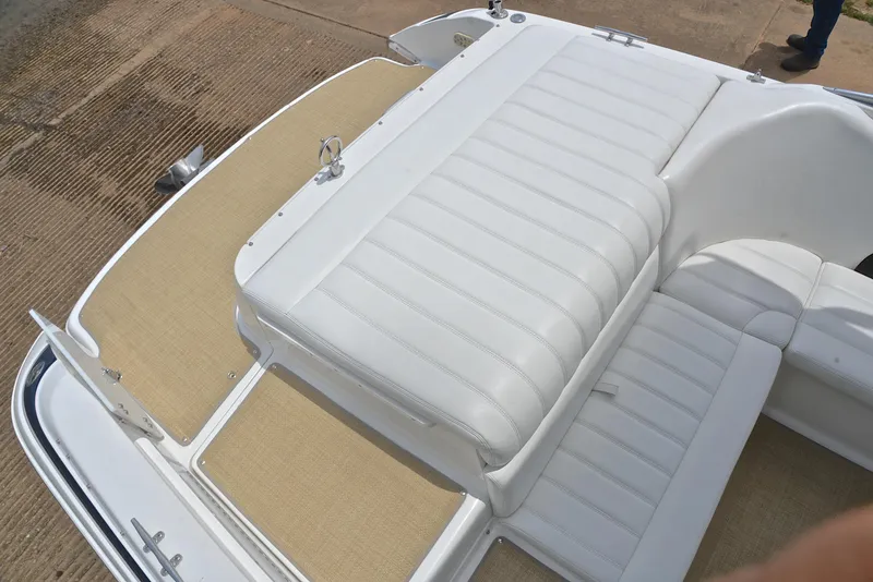 Slide: The Image of White leather seating on a 2000 Cobalt 246 boat, featuring beige flooring. - 24