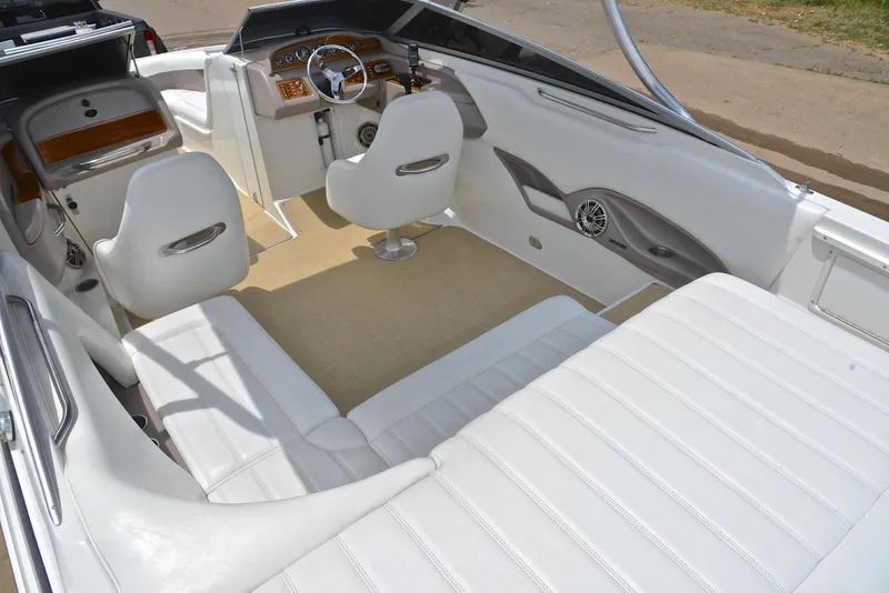 Slide: The Image of Interior of a 2000 Cobalt 246 boat with white seating and modern dashboard. - 25