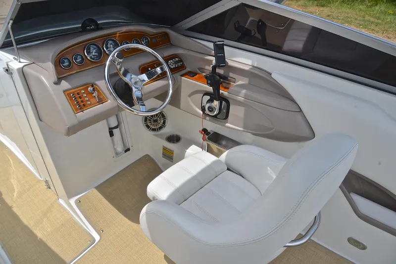 Slide: The Image of Interior of a 2000 Cobalt 246 boat with steering wheel and control panel. - 26