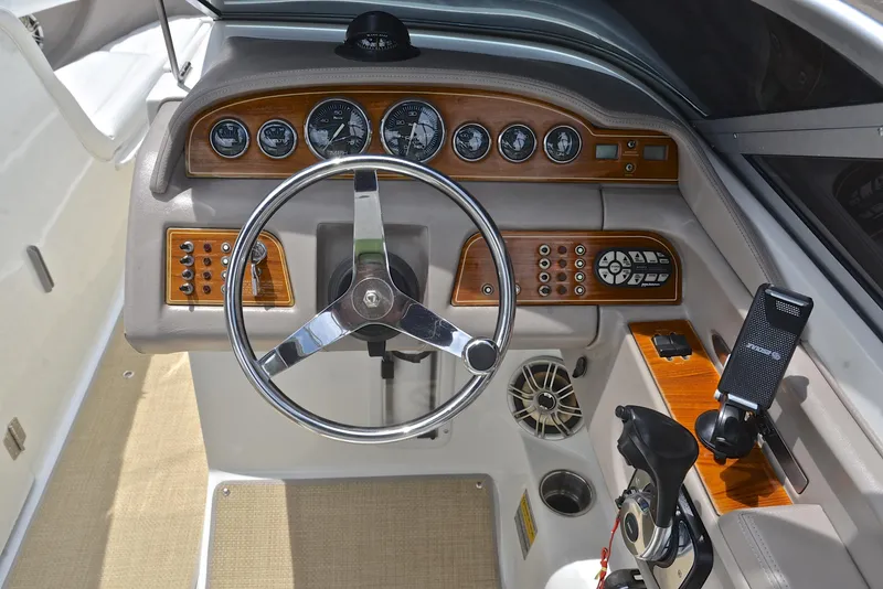 Slide: The Image of Interior of a 2000 Cobalt 246 boat with steering wheel and control panel. - 27