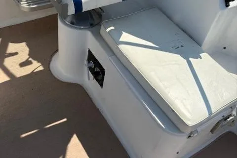 Slide: The Image of 1995 Wellcraft 23 Excel boat interior with white seating and control panel. - 11