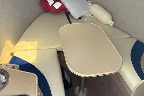 Slide: The Image of 1995 Wellcraft 23 Excel boat interior with seating and table setup. - 12