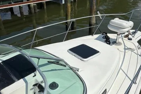 Slide: The Image of 1995 Wellcraft 23 Excel boat docked, featuring a sleek white deck and railing. - 16